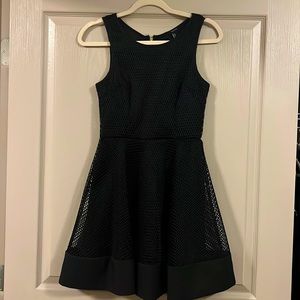 Black net dress with gold zipper